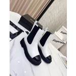 CHANEL puts on his boots with one foot