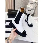 CHANEL puts on his boots with one foot