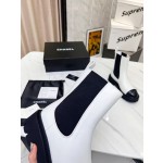 CHANEL puts on his boots with one foot