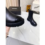 CHANEL puts on his boots with one foot